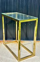 Full view of brass frame side table with glass top