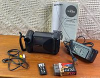 Camcorder, manual, charger, remote, tape, batteries (inside charger), cable