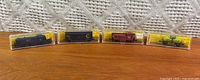 All four boxed Atlas N-scale train items lined up