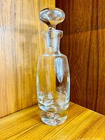 Full view of crystal decanter standing upright