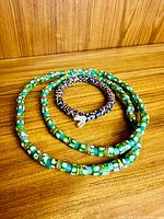 Necklace and bracelet laid flat showing bead colours and patterns