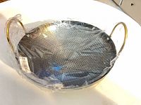 Top view of skillet in plastic wrap showing honeycomb interior and handles