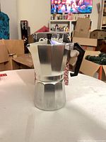 Moka pot front view showing full body and handle