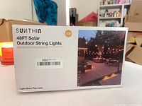 Front of SUNTHIN box showing product name and patio image