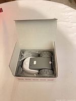 Open box showing robotic mouse toy inside