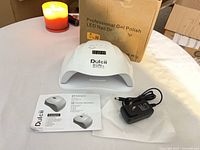 Lamp, adapter, manual and box on table