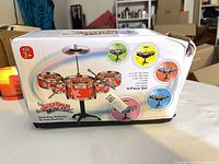 Front of box showing Jazz Drum Musical 9-piece electronic toy drum set, age 3+ warning