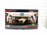 Front of retail box showing JVJ brand and in-car screen setup