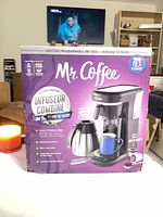 Front of sealed box showing Mr. Coffee Combo Brewer image and features