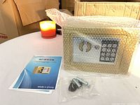 Safe wrapped in bubble film with manual and hardware