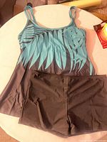 Front view of tankini swimdress top with palm print and matching swim shorts