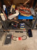 Overall lot on shelving with V-belt, snow brush, booster cables, extension cord, trouble light and assorted cleaning items