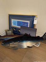 Group view showing shadowbox, metal fish, stuffed fish, small print
