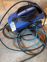 Full view of Simoniz 1600 PSI washer with hose and cords