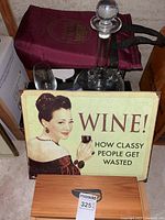 Assortment with sign, tall decanter, wine glass, wooden box