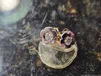 Front view of both flower stud earrings showing diamonds