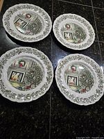 Four Johnson Bros. Merry Christmas plates front view