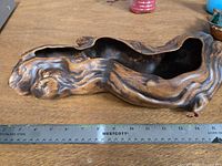 Top view of ceramic log planter with open cavity and ruler for scale