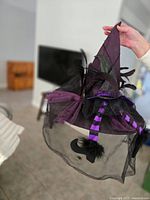 Purple witches hat with feathers, mesh, ribbons, tulle drape and spider