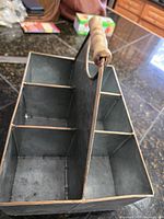 Top angle view showing four compartments, wood grip handle and galvanized finish