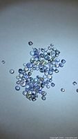 Loose round light violet-blue tanzanite stones spread on surface