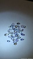 Group of loose oval cut tanzanites under spotlight