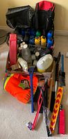 Box containing assorted oil quarts, cleaning jugs, Toyota bags, snow tools, hoodie and vest