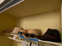 Shelf view showing four hats in a row