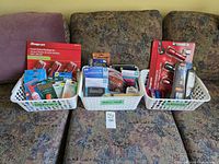 Wide shot of all three baskets showing mixed electronics accessories and flashlights