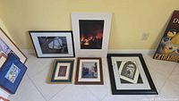 Group shot of all six framed artworks leaning against wall