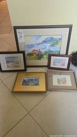 Group shot of five framed artworks