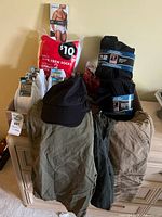Overview of all items on dresser: shorts, caps, various packaged socks, underwear pack