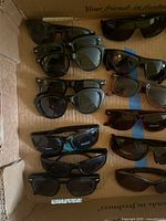 Box containing multiple pairs of sunglasses