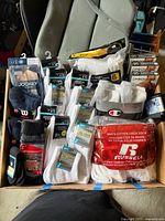 Overview of all sealed sock and underwear packages inside box