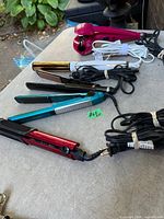 Group of hair tools laid out showing variety and cords