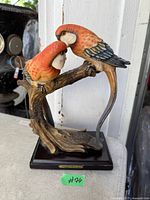 Front view of two-bird figurine on base