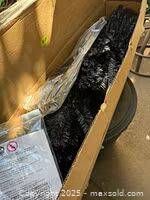 Boxed artificial black Christmas tree parts