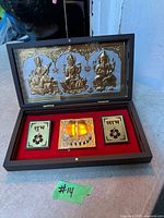 Open presentation case showing gold-plated plaques and velvet interior