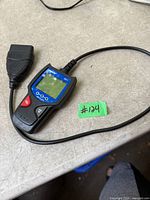 Front view of Innova 3011 code reader with attached OBD-II cable