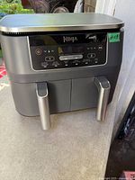Front view of Ninja dual-drawer air fryer showing control panel and handles