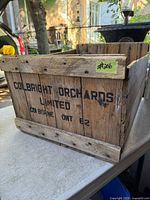 Front view showing stencilled Colbright Orchards lettering and overall crate condition