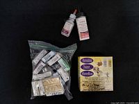 Overall lot with bag of clay bricks, two liquid bottles and boxed kit