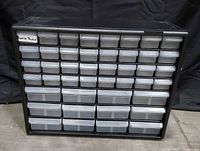Front view of black plastic organizer showing all 44 clear drawers
