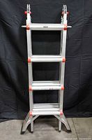 Full front view of folded Little Giant Helium ladder showing rungs and flared legs