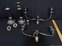 Full lot with candlesticks, candelabra arms, bobeches, ruler for scale