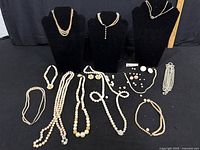 Overall lot showing necklaces on busts and loose pieces