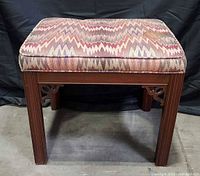 Front view of bench showing wooden frame and upholstered seat