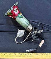 Full view of stained glass floral lamp with measuring tape for scale