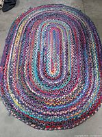 Full view of oval braided rug showing overall size and color pattern