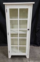 Front view of white glass-door display cabinet showing full height and design details